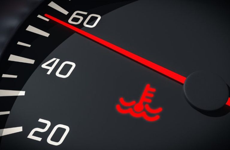 The warning sign of an overheated engine on a gauge cluster